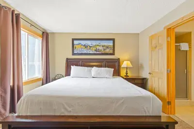 a bedroom with a large white bed and a window at Rocky Mountain Escape with Vista View - Wildernest in Silverthorne