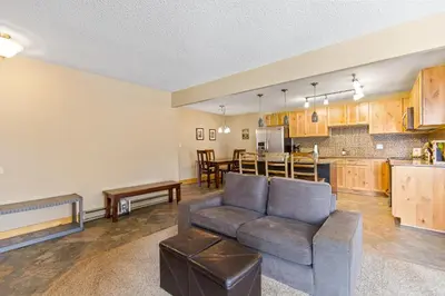 a living room with a couch and a kitchen at Rocky Mountain Escape with Vista View - Wildernest in Silverthorne