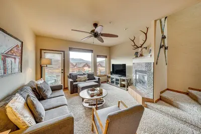 a living room with a couch and a fireplace at 6 Mi to Winter Park Resort Townhome with Hot Tub! in Fraser