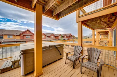 two chairs sitting on a deck with a stove at 6 Mi to Winter Park Resort Townhome with Hot Tub! in Fraser