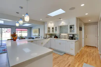 a large kitchen with white cabinets and a kitchen island at Private Hot Tub and Sauna Saulsbury Guest House in Wheat Ridge