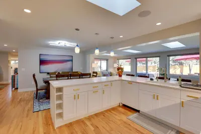 a kitchen with white cabinets and a dining room at Private Hot Tub and Sauna Saulsbury Guest House in Wheat Ridge