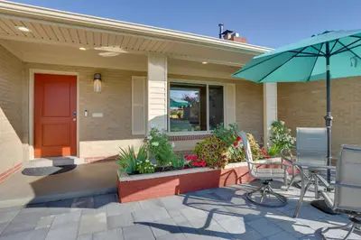 a house with a patio with a table and an umbrella at Private Hot Tub and Sauna Saulsbury Guest House in Wheat Ridge