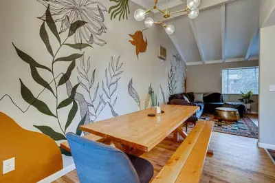 a dining room with a wooden table and blue chairs at Close to Denver & Golden - Perfect for Groups in Arvada