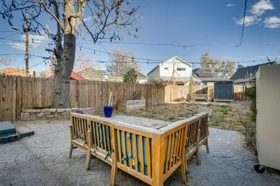 a backyard with a wooden fence and a wooden table at Cozy and Pet-Friendly Home - 3 Mi to Downtown Denver in Denver