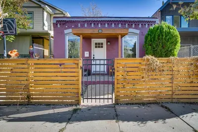 a wooden fence in front of a house at Cozy and Pet-Friendly Home - 3 Mi to Downtown Denver in Denver