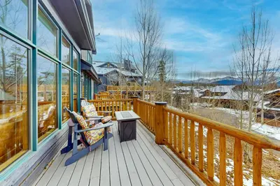 a porch with a bench and a table on a deck at Sundance Mountain Retreat in Fraser