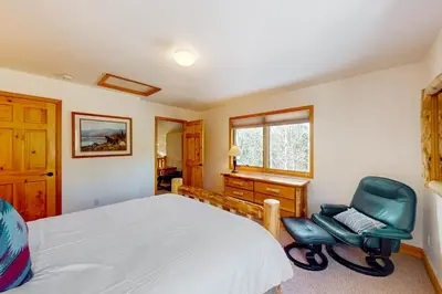 a bedroom with a bed and a desk and a chair at Sundance Mountain Retreat in Fraser