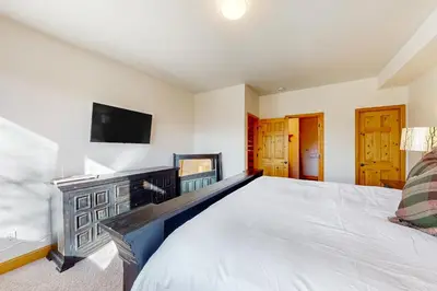 a bedroom with a bed and a flat screen tv at Sundance Mountain Retreat in Fraser