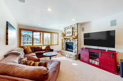 a living room with couches and a flat screen tv at Sundance Mountain Retreat in Fraser