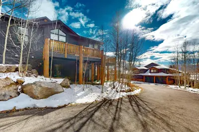a house with a deck on the side of the road at Sundance Mountain Retreat in Fraser