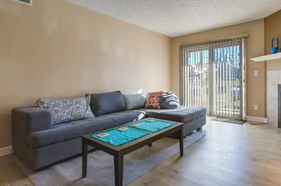 a living room with a couch and a coffee table at 1 Mi to Light Rail Englewood Condo with Pool Access in Englewood