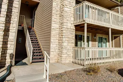a house with a staircase on the side of it at 1 Mi to Light Rail Englewood Condo with Pool Access in Englewood