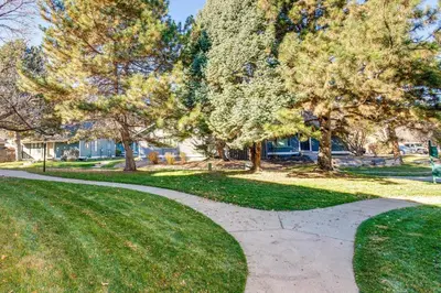 a walkway in a park with trees and grass at 1 Mi to Light Rail Englewood Condo with Pool Access in Englewood