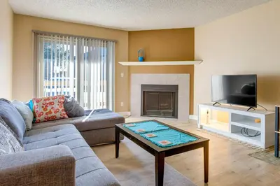 a living room with a couch and a tv at 1 Mi to Light Rail Englewood Condo with Pool Access in Englewood