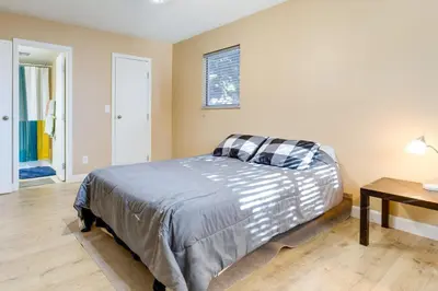 a bedroom with a bed in a room with a table at 1 Mi to Light Rail Englewood Condo with Pool Access in Englewood