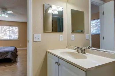 a bathroom with a sink and a mirror at 1 Mi to Light Rail Englewood Condo with Pool Access in Englewood