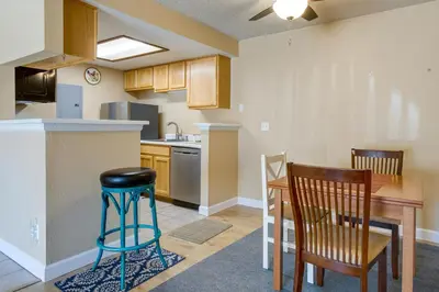 a kitchen with a table and chairs and a counter at 1 Mi to Light Rail Englewood Condo with Pool Access in Englewood
