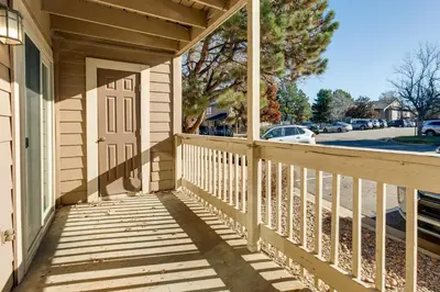 a wooden porch of a house with a door at 1 Mi to Light Rail Englewood Condo with Pool Access in Englewood