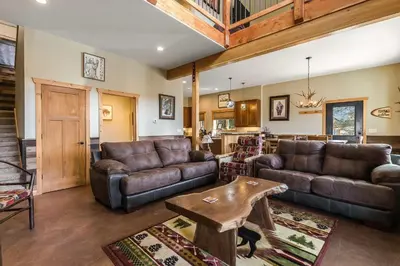 a living room with leather couches and a table at Show Me Mountain Views -- 20-NCD0130 home in Estes Park