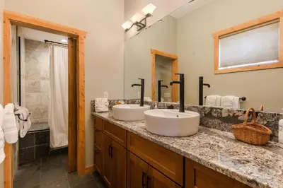 a bathroom with two sinks and a shower at Show Me Mountain Views -- 20-NCD0130 home in Estes Park