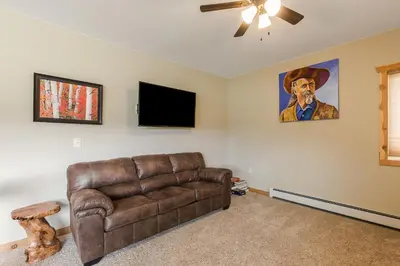 a living room with a couch and a flat screen tv at Show Me Mountain Views -- 20-NCD0130 home in Estes Park