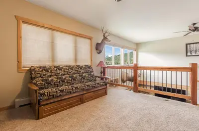 a living room with a couch and a window at Show Me Mountain Views -- 20-NCD0130 home in Estes Park
