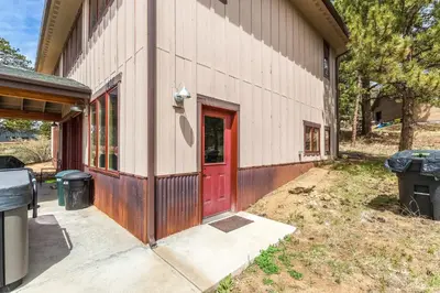 a house with a red door on the side of it at Show Me Mountain Views -- 20-NCD0130 home in Estes Park