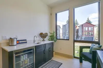a kitchen with a sink and a counter with windows at Ski, Hike and Relax Fireside Silverthorne Getaway! in Silverthorne