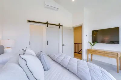 a white bedroom with a large white bed with pillows at Ski, Hike and Relax Fireside Silverthorne Getaway! in Silverthorne