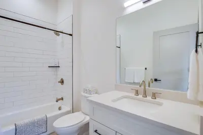 a white bathroom with a sink and a toilet at Ski, Hike and Relax Fireside Silverthorne Getaway! in Silverthorne