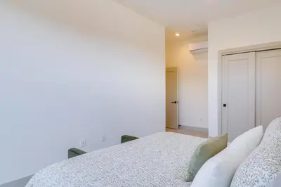 a white bedroom with a bed and a closet at Ski, Hike and Relax Fireside Silverthorne Getaway! in Silverthorne