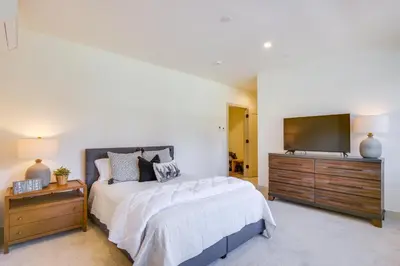 a bedroom with a bed and a flat screen tv at Ski, Hike and Relax Fireside Silverthorne Getaway! in Silverthorne