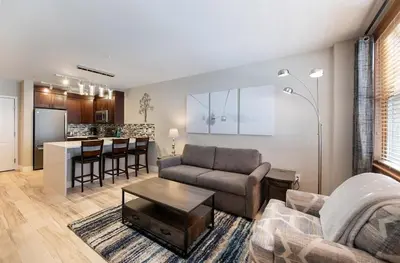 a living room with a couch and a table at Premium Unit 1307 - 1 Bedroom - Zephyr Mountain condo in Winter Park