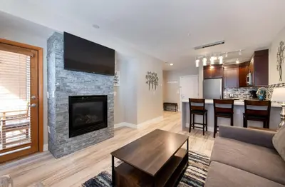 a living room with a couch and a fireplace at Premium Unit 1307 - 1 Bedroom - Zephyr Mountain condo in Winter Park