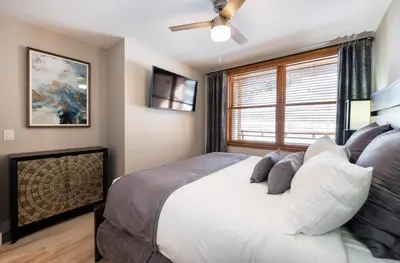a bedroom with a large bed and a window at Premium Unit 1307 - 1 Bedroom - Zephyr Mountain condo in Winter Park