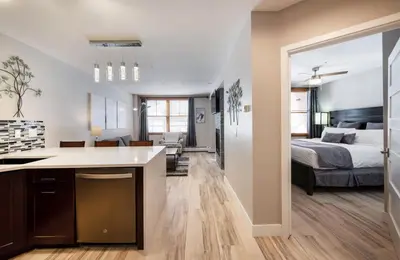 a kitchen and living room with a bed in a room at Premium Unit 1307 - 1 Bedroom - Zephyr Mountain condo in Winter Park