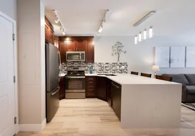a kitchen with a refrigerator and a counter top at Premium Unit 1307 - 1 Bedroom - Zephyr Mountain condo in Winter Park