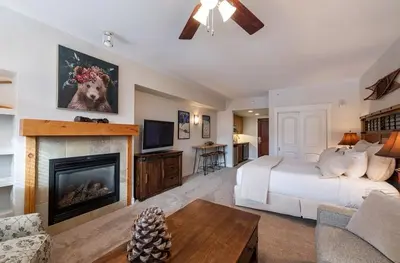 a large bedroom with a bed and a fireplace at Premium Unit 4643- Fraser Crossing Founders Pointe condo in Winter Park