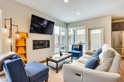a living room with a couch and chairs and a tv at Ski-InandSki-Out Granby Getaway with Fire Pit! in Granby