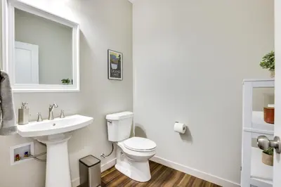 a white bathroom with a sink and a toilet at Ski-InandSki-Out Granby Getaway with Fire Pit! in Granby