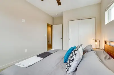 a white bedroom with a large bed with pillows at Ski-InandSki-Out Granby Getaway with Fire Pit! in Granby