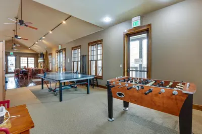 a room with a ping pong table in it at Ski-InandSki-Out Granby Getaway with Fire Pit! in Granby
