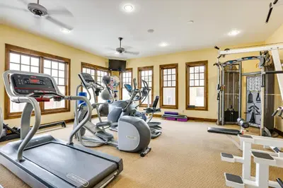 a fitness room with treadmills and ellipticals at Ski-InandSki-Out Granby Getaway with Fire Pit! in Granby
