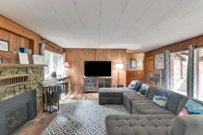a living room with a couch and a fireplace at Charming Idaho Springs Retreat on Chicago Creek! in Idaho Springs