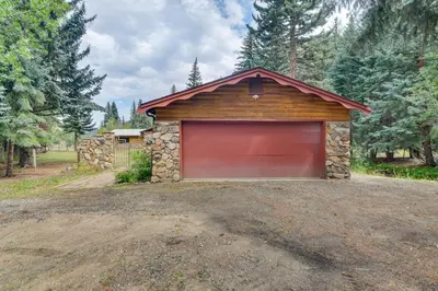 a garage with a red garage door in a driveway at Charming Idaho Springs Retreat on Chicago Creek! in Idaho Springs