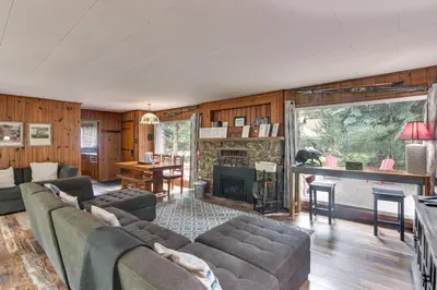 a living room with a couch and a fireplace at Charming Idaho Springs Retreat on Chicago Creek! in Idaho Springs