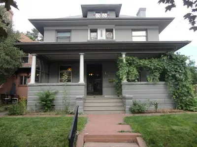 a white house with a walkway in front of it at 2-Bedroom in the Heart of Denver in Denver