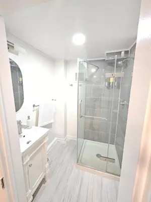 a bathroom with a glass shower and a sink at 2-Bedroom in the Heart of Denver in Denver