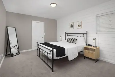 a bedroom with a bed and a dresser and a mirror at Spacious home near Anschutz/DIA in Aurora